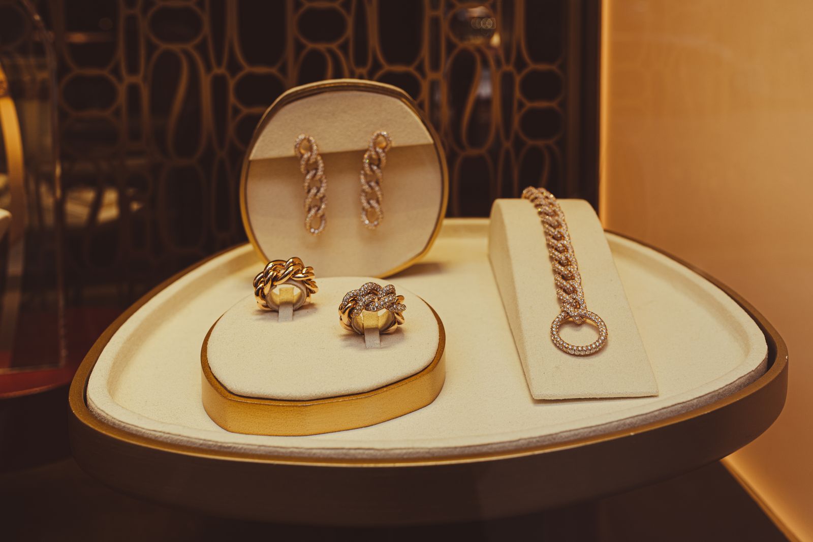 Gold earrings, rings, and a bracelet displayed in a jewelry showcase